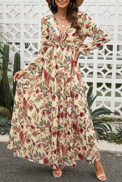 Model wearing size small boho floral maxi dress with frill details, long sleeves, and plunging neckline – front view.