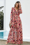Model wearing size small pink ruched midi dress with long sleeves, lined body, and modest silhouette looking down– front view.