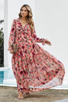 Model wearing size small pink ruched midi dress with long sleeves, lined body, and modest silhouette – front view of model walking and wind blowing into dress.