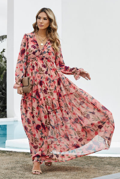 Model wearing size small pink ruched midi dress with long sleeves, lined body, and modest silhouette – front view of model walking and wind blowing into dress.