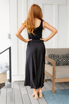 Back view showing elastic waistband and modest maxi length skirt on model