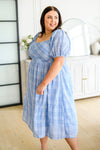 Side profile of Skylar midi dress with puff sleeves and flowy skirt in blue plaid plus size