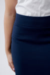 Close-up detail of stretchy elastic waistband on pencil skirt