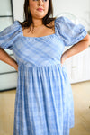 Detailed view of smocked bodice and neckline on blue plaid Skylar midi dress plus size