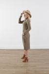 Side of checkered cocoon modest dress with mock neck, welt pockets, knee-length silhouette, and stretchy knit polyester fabric