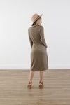 Back of checkered cocoon modest dress with mock neck, welt pockets, knee-length silhouette, and stretchy knit polyester fabric
