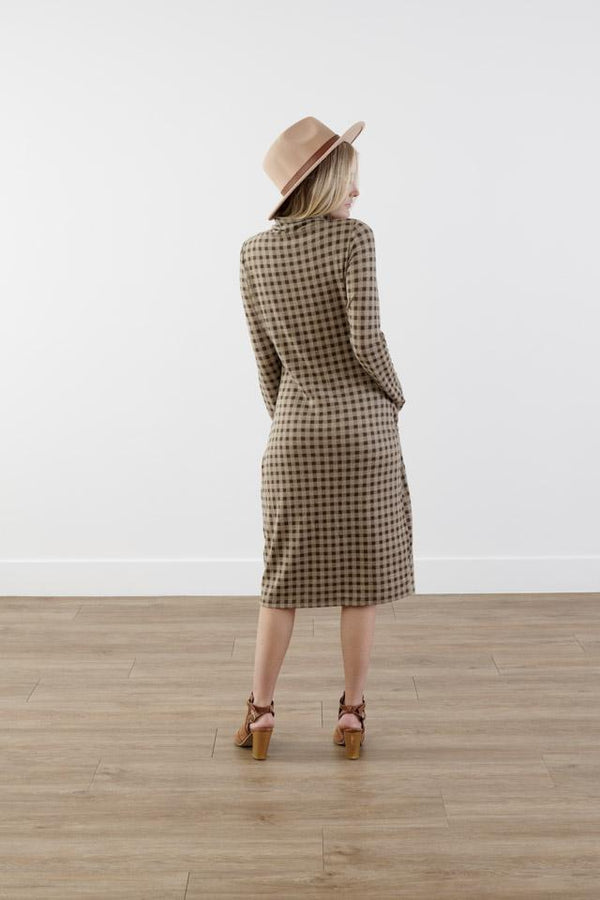 Back of checkered cocoon modest dress with mock neck, welt pockets, knee-length silhouette, and stretchy knit polyester fabric