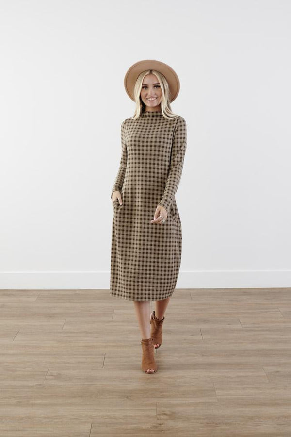 Checkered cocoon modest dress with mock neck, welt pockets, knee-length silhouette, and stretchy knit polyester fabric