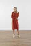 Rich-toned modest knit dress with long puff sleeves, straight silhouette, and knee-length hem, made from cozy polyester-rayon-spandex blend