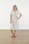 Plus size cotton midi dress with chest pocket, decorative side buttons, elastic waist with sash, and A-line skirt in breathable white fabric