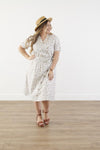 Plus size cotton midi dress with chest pocket, decorative side buttons, elastic waist with sash, and A-line skirt in breathable white fabric