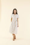 Cotton midi dress with chest pocket, decorative side buttons, elastic waist with sash, and A-line skirt in breathable white fabric