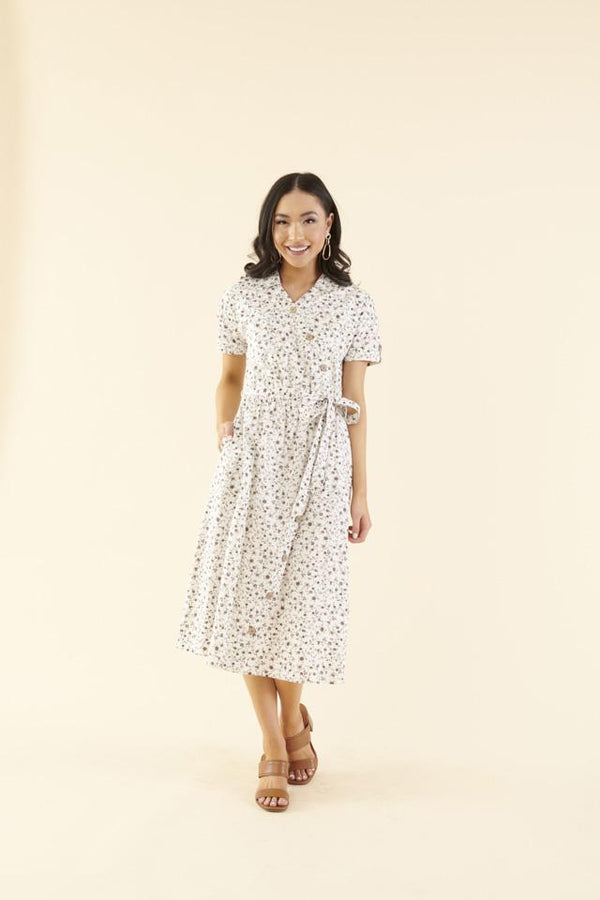 Cotton midi dress with chest pocket, decorative side buttons, elastic waist with sash, and A-line skirt in breathable white fabric