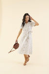 Cotton midi dress with chest pocket, decorative side buttons, elastic waist with sash, and A-line skirt in breathable white fabric