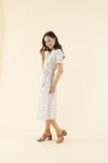 Cotton midi dress with chest pocket, decorative side buttons, elastic waist with sash, and A-line skirt in breathable white fabric