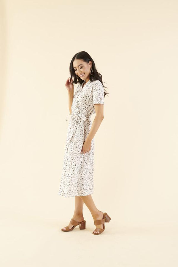 Cotton midi dress with chest pocket, decorative side buttons, elastic waist with sash, and A-line skirt in breathable white fabric