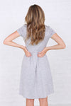 Back of Modest knee-length fit and flare dress with elastic waist in soft polyester-spandex fabric.