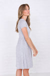  Side of modest knee-length fit and flare dress with elastic waist in soft polyester-spandex fabric.